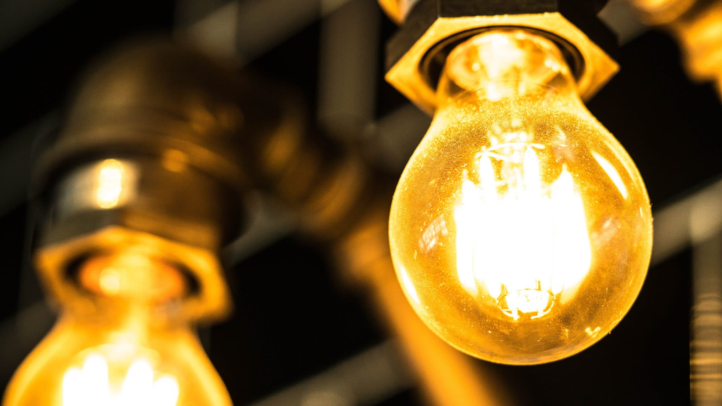 Stylized lightbulb with a blurred background, representing ideas and illumination for Epic Electrical Services.